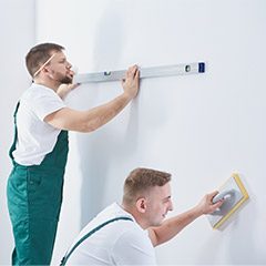 Team members finishing interior painting
