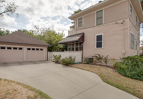 Pink-colored house and garage