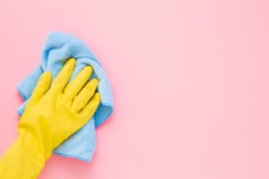 person with a glove washing the walls
