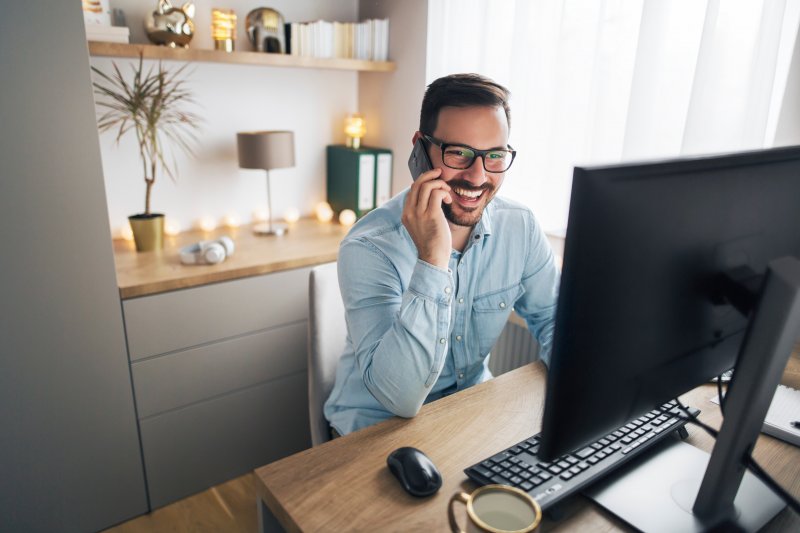 man talking on phone in home office