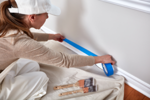 a person painting an indoor wall 