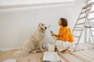 a woman and her dog with paint 